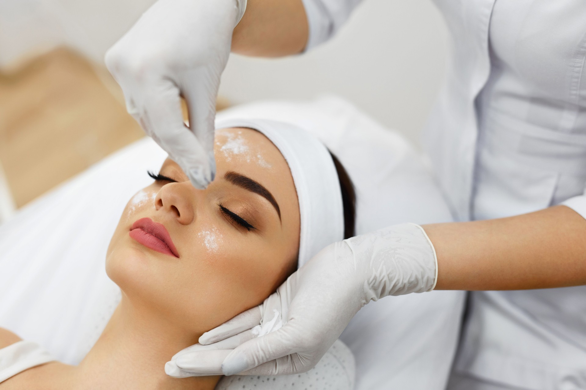 Girl At Spa Salon. Beautician Applying White Cosmetic Powder